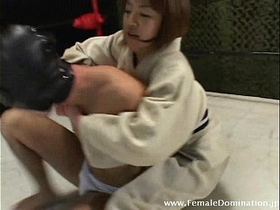Collared slave is totally b. up by a domina in the ring